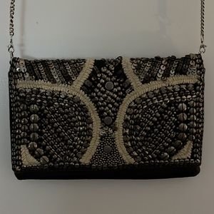 Clutch with removable metal chain